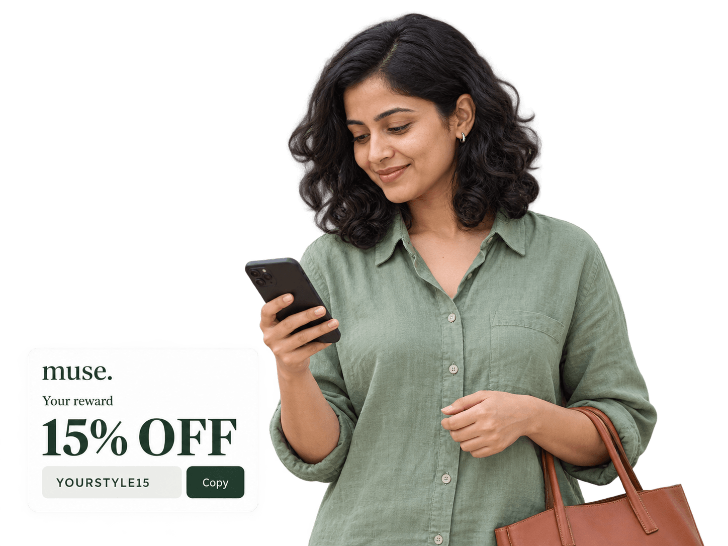 A shopper in a sage shirt checking her phone, with a leather tote and a MUSE 15 percent off reward